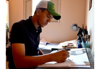 Leandro André, no seu espaço criativo, produzindo novo retrato com lápis e papel (Foto: Acácio Rocha).