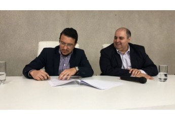 Reitor Paulo Sérgio e vice-reitor Fábio Botteon na assinatura do convênio (Foto: Maikon Moraes).