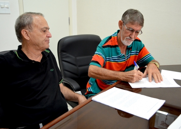 Antônio Rivelin assina o pedido de CIP contra o prefeito Ivo Santos, observado por Aguinaldo Galvão, presidente do DEM de Adamantina (Foto: Acácio Rocha).