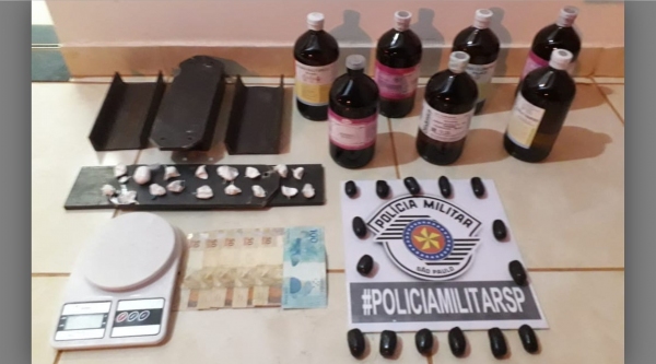 Polícia apreende cocaína, dinheiro, balança de precisão, além de produtos químicos e a prensa usada no preparo da droga (Foto: Cedida/PM).
